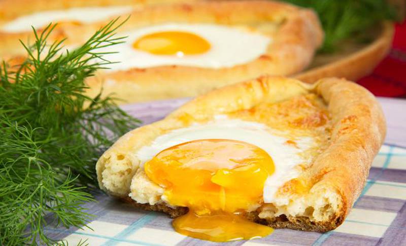 ajarian khachapuri dish of Georgian cuisine, Georgian national pastry, which is a flatbread with cheese. baked in the shape of boats and pour the egg