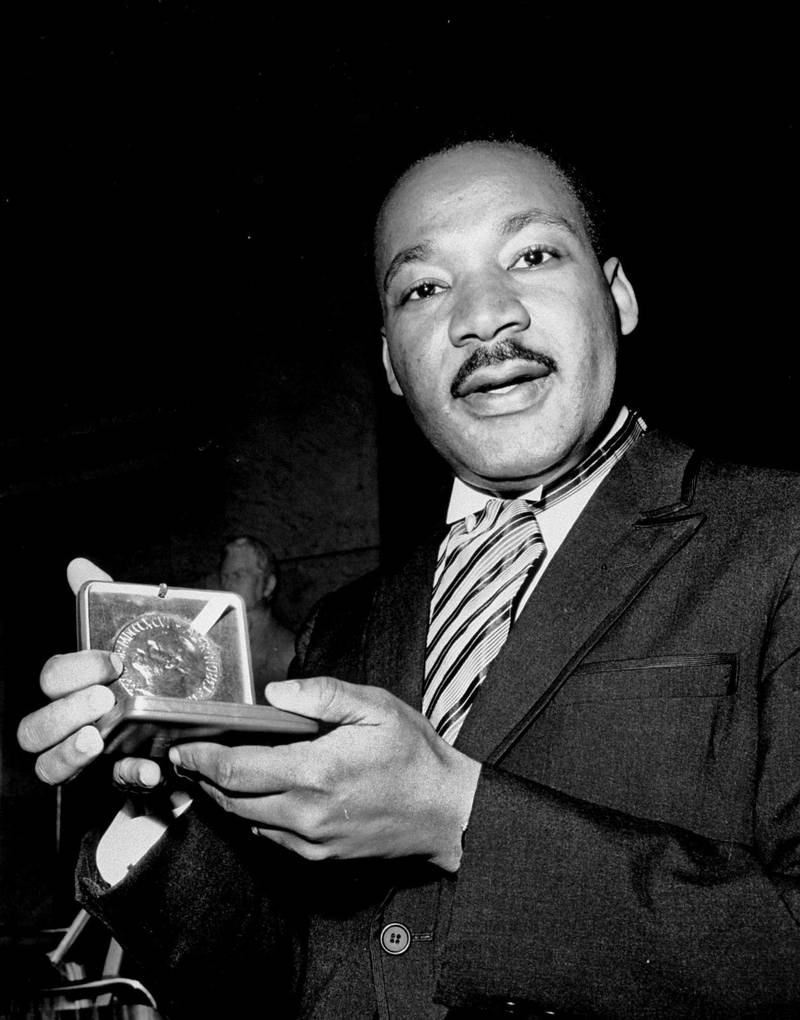 In this Dec. 10, 1964, file photo, U.S. civil rights leader Dr. Martin Luther King, Jr. holds his 1964 Nobel Peace Prize medal in Oslo, Norway. King was honored for promoting the principle of non-violence in the civil rights movement. (AP Photo, File) / TT / kod 436