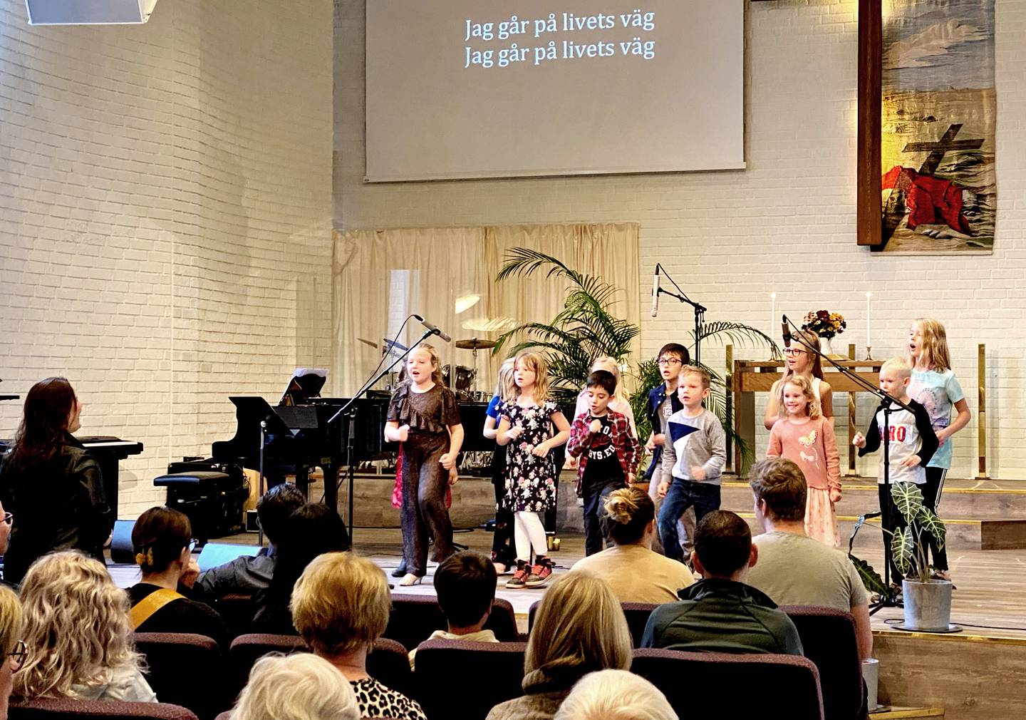 Barnkör sjunger "Jag går på livets väg" i Aspnäskyrkan i Jakobsberg.