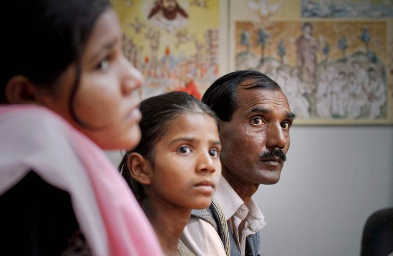 Ashif Masih, right, husband of  Christian woman Asia Bibi who had been sentenced to death, and  daughters Sidra Shahzadi and Isham Ashiq listen to Pakistani minister for Minority Affairs Shahbaz Bhatti, unseen, during a meeting in Islamabad, Pakistan on Wednesday, Nov. 24, 2010. The case against Bibi, which started with a spat over people of different religions drinking from the same cup, has renewed calls for reform of Pakistan's blasphemy law, which critics say have been used to settle grudges, persecute minorities and fan religious extremism. (AP Photo/Anjum Naveed)