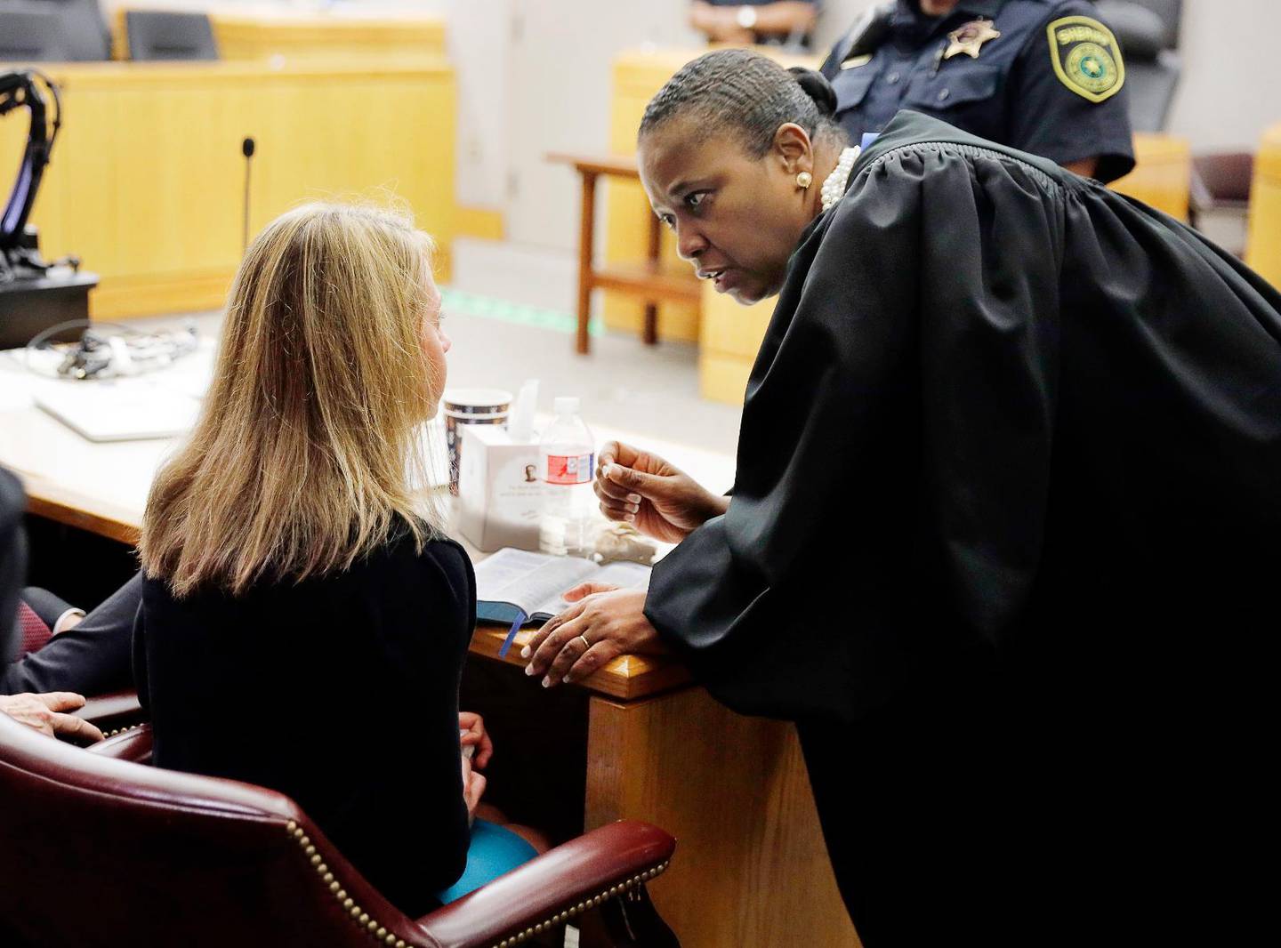 Former Dallas Police Officer Amber Guyger, left, listens to words of advice and encouragement from State District Judge Tammy Kemp after the judge had given her a Bible and before Guyger left for jail, Wednesday, Oct. 2, 2019, in Dallas. Guyger, who said she mistook neighbor Botham Jean''s apartment for her own and fatally shot him in his living room, was sentenced to a decade in prison. (Tom Fox/The Dallas Morning News via AP, Pool)  TXDAM611