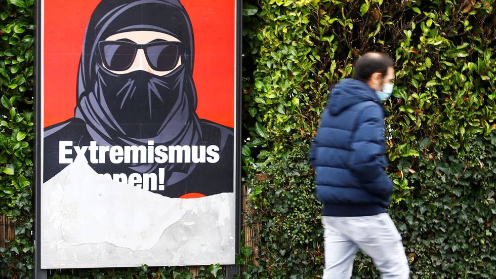 A partially torn poster of the initiative committee against wearing the Burka (Verhuellungsverbot) reading "Stop extremism! Veil ban -Yes" is seen in Zurich, Switzerland February 2, 2021. On March 7 Switzerland's voters will decide about a nationwide veil ban.  REUTERS/Arnd Wiegmann  X90184