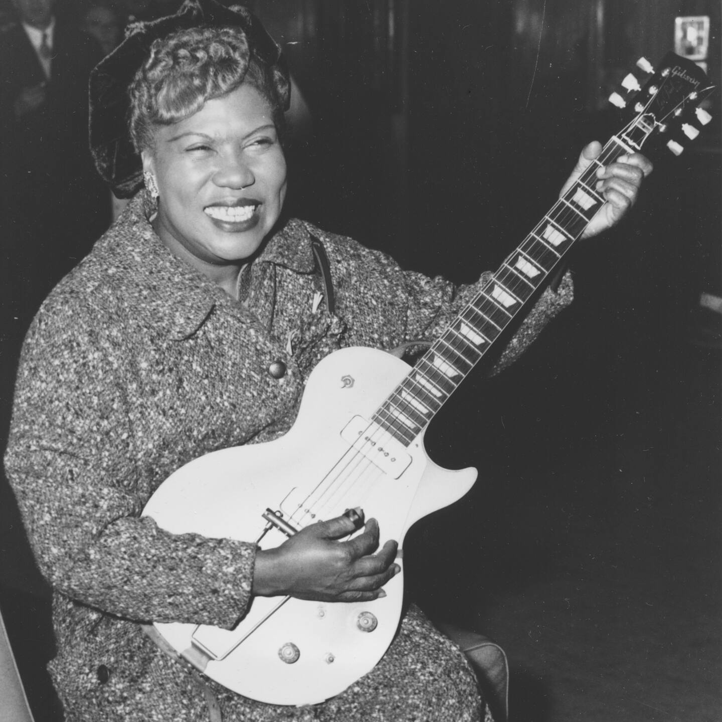 Sister Rosetta Tharpe, guitar-playing American gospel singer, gives an inpromptu performance in a lounge at London Airport, following her arrival from New York on November 21, 1957. (AP Photo)