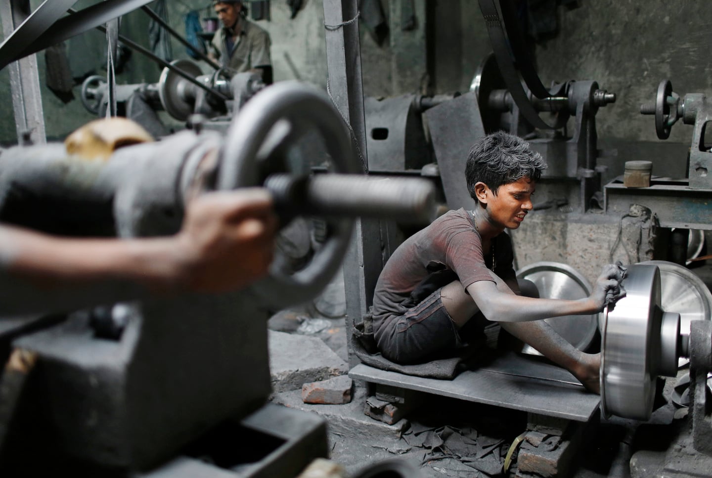 In this Sunday, June 12, 2016, photo, Nizam, 11, works at a factory that makes metal utensils in Dhaka, Bangladesh. The World Day Against Child Labor, which was initiated in 2002 by the International Labor Organization to highlight the plight of child laborers, is observed across the world on June 12. (AP Photo/A.M. Ahad)